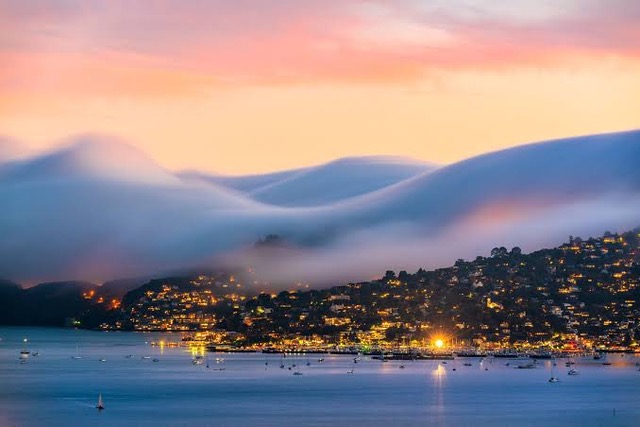 Sausalito coastline with fog and glowing sunset