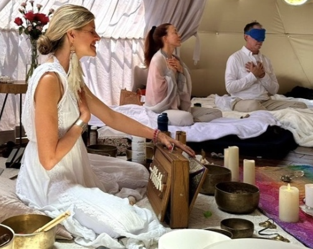 Lisa leading a ceremony inside the dome sanctuary with guests in meditation