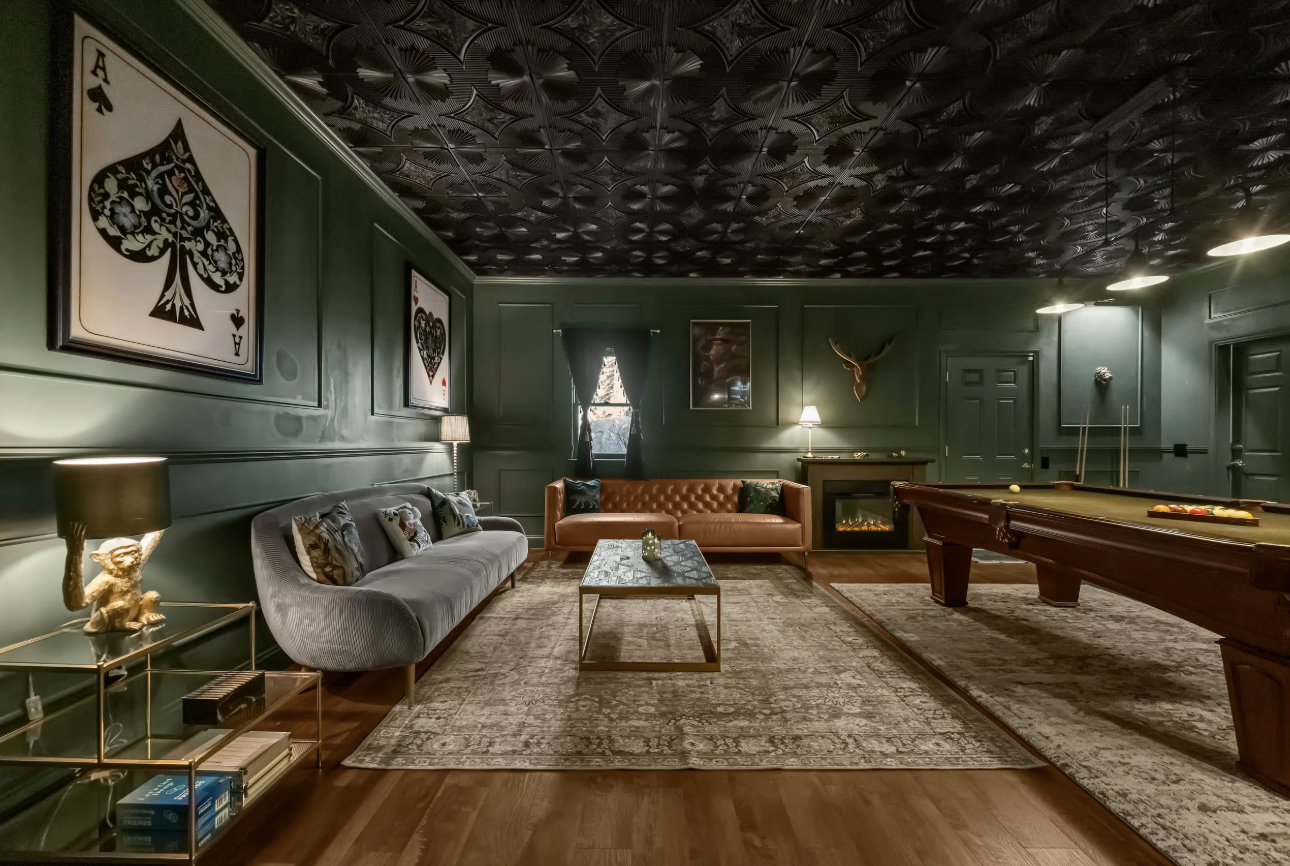 Green lounge room with billiards table and fireplace